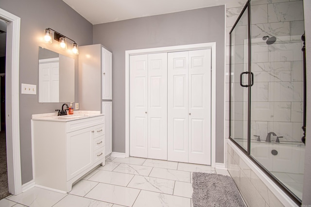 bathroom with a shower with door and vanity