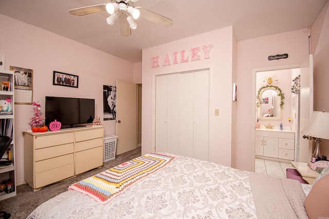 carpeted bedroom featuring ceiling fan and a closet