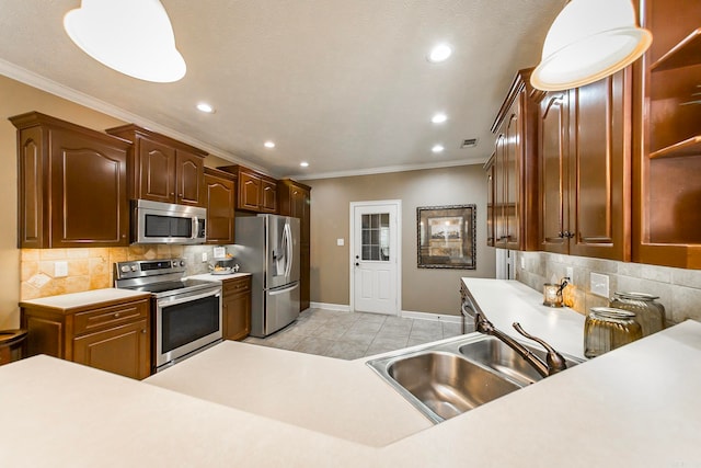 kitchen with light tile patterned flooring, ornamental molding, decorative light fixtures, backsplash, and appliances with stainless steel finishes