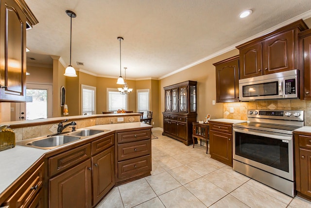 kitchen featuring a notable chandelier, hanging light fixtures, stainless steel appliances, light tile patterned floors, and crown molding