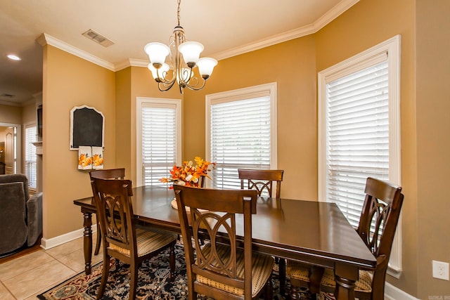 tiled dining room featuring an inviting chandelier and crown molding