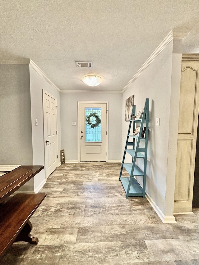 265 Pleasant Oaks Loop, El Paso, AR 72045 - entryway with ornamental molding, wood finished floors, a textured ceiling, and visible vents