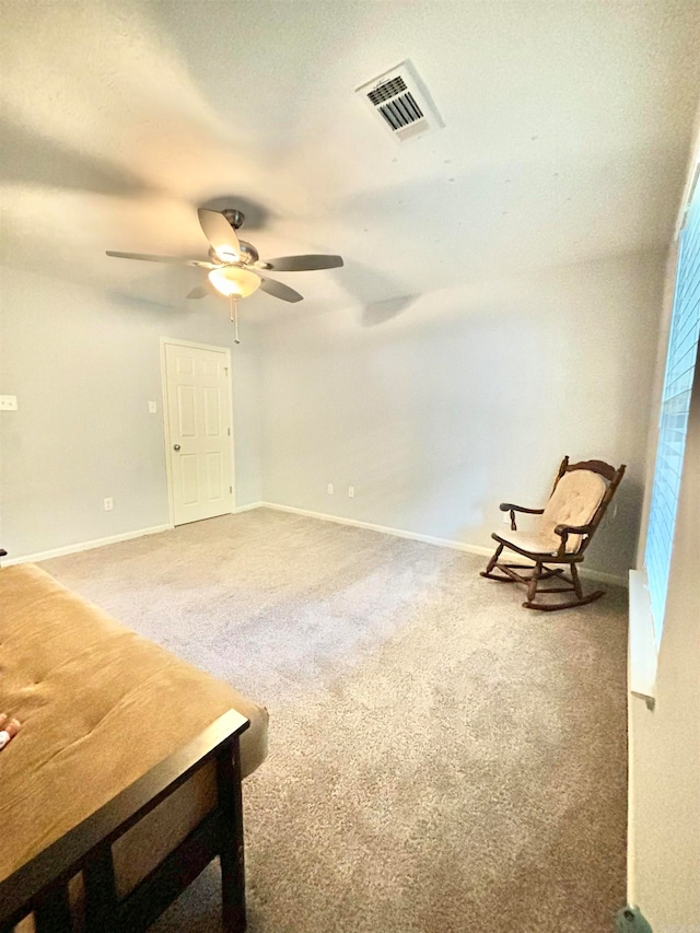 sitting room with carpet and ceiling fan