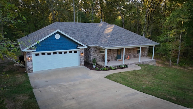 view of front facade with a front lawn, a porch, and a garage