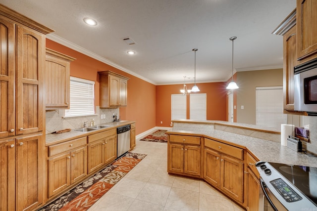 kitchen featuring appliances with stainless steel finishes, pendant lighting, an inviting chandelier, ornamental molding, and sink