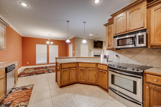 kitchen featuring hanging light fixtures, an inviting chandelier, appliances with stainless steel finishes, light tile patterned floors, and crown molding