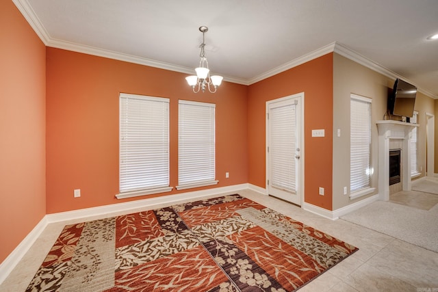 tiled entryway featuring ornamental molding and an inviting chandelier