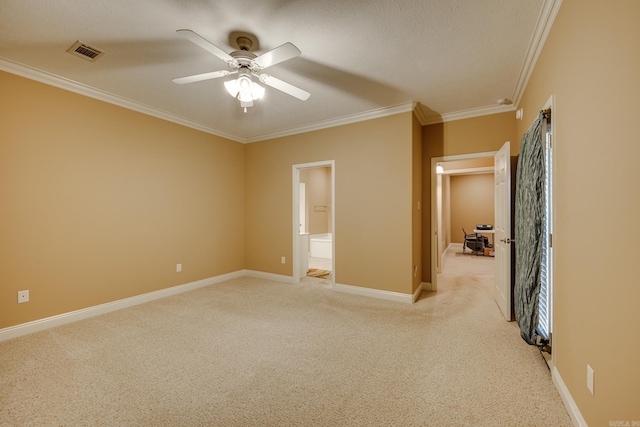 unfurnished bedroom with ceiling fan, ensuite bath, light carpet, and ornamental molding