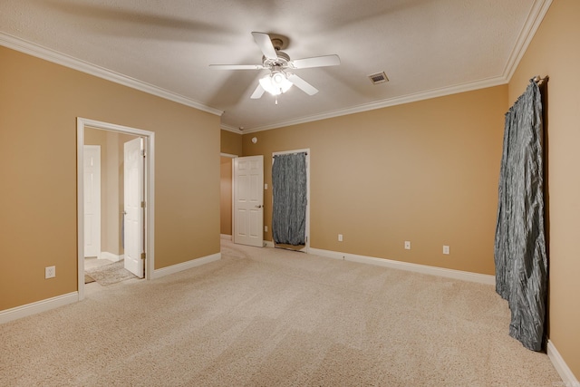 unfurnished bedroom with ceiling fan, light colored carpet, a textured ceiling, and ornamental molding