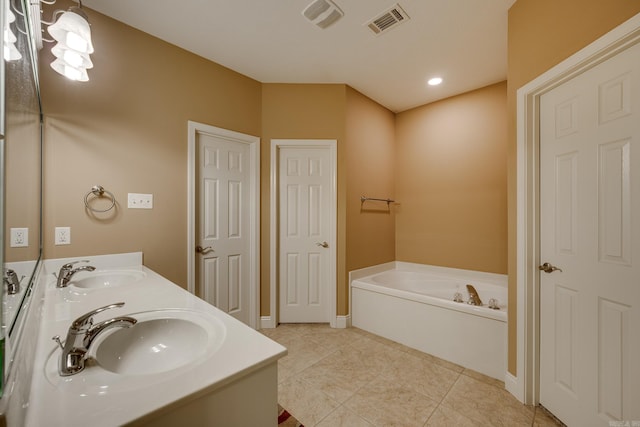 bathroom featuring vanity, tile patterned flooring, and a washtub