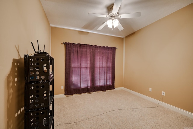 carpeted empty room featuring ceiling fan