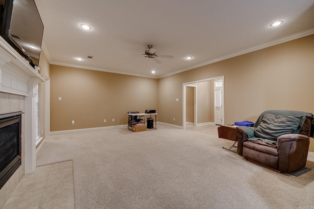 sitting room featuring ceiling fan, light colored carpet, a fireplace, and ornamental molding