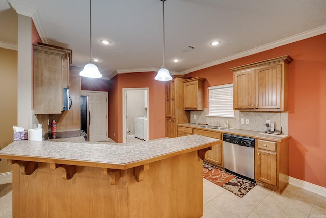 kitchen featuring appliances with stainless steel finishes, hanging light fixtures, and crown molding