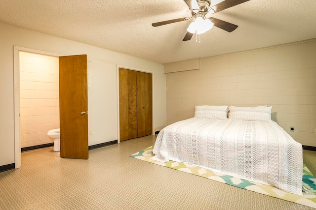 bedroom with a closet, ceiling fan, ensuite bathroom, and a textured ceiling