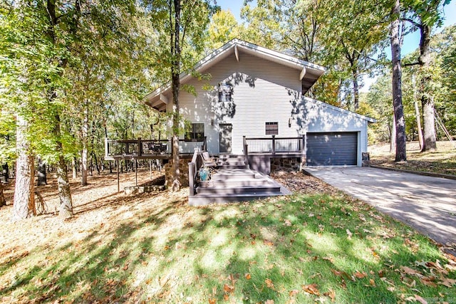 exterior space with a garage and a wooden deck