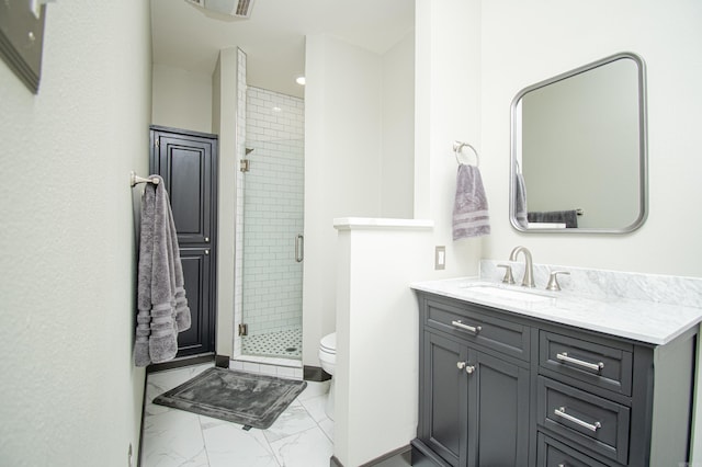bathroom with marble finish floor, vanity, toilet, and a shower stall