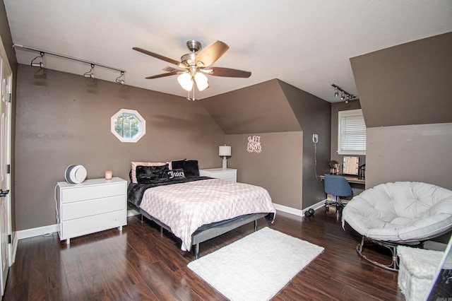 bedroom featuring vaulted ceiling, baseboards, ceiling fan, track lighting, and wood finished floors