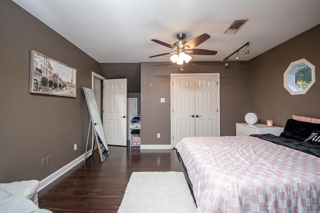 bedroom featuring baseboards, visible vents, a closet, ceiling fan, and wood finished floors