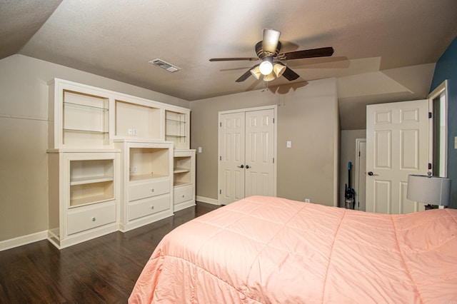 bedroom featuring visible vents, baseboards, ceiling fan, dark wood-type flooring, and vaulted ceiling