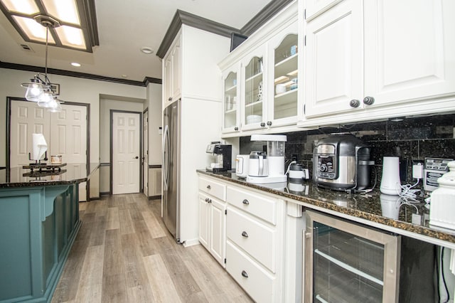 bar featuring decorative backsplash, ornamental molding, light wood-style floors, and beverage cooler