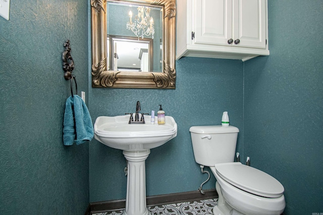 bathroom with baseboards and toilet