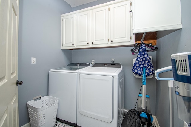 washroom featuring washing machine and dryer and cabinet space