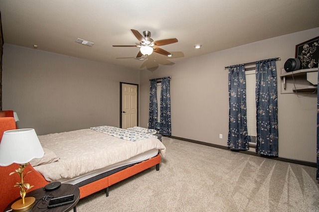 bedroom featuring baseboards, visible vents, carpet floors, and a ceiling fan