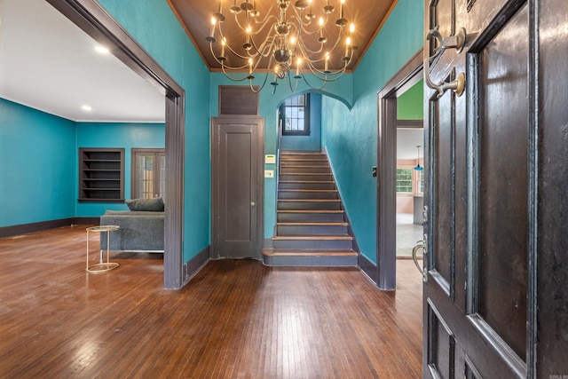 foyer with ornamental molding, dark hardwood / wood-style floors, and plenty of natural light