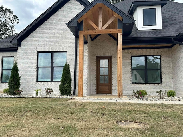 entrance to property featuring a lawn