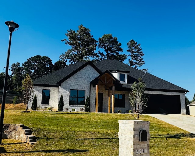 view of front of property featuring a garage and a front yard