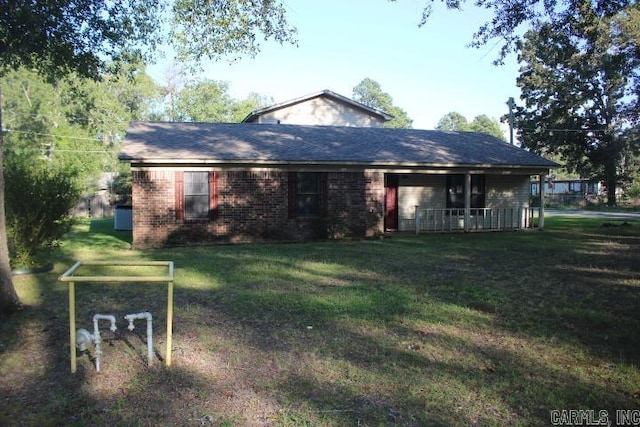 rear view of property with a yard