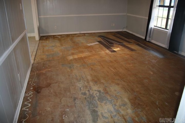 empty room with dark hardwood / wood-style flooring