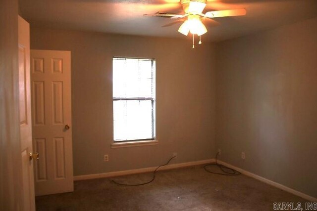 unfurnished room with carpet flooring and ceiling fan