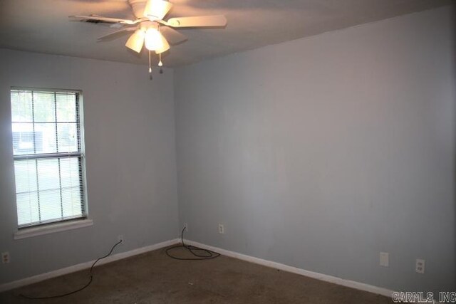 carpeted spare room with ceiling fan