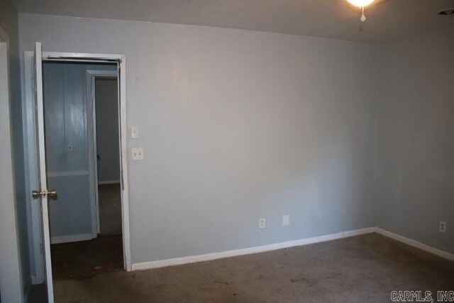 empty room with dark carpet