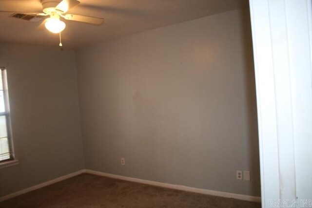 carpeted spare room with ceiling fan