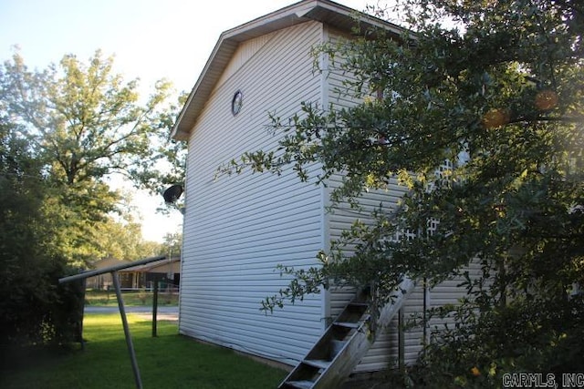 view of side of home featuring a yard