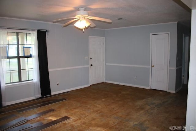 empty room featuring ornamental molding, a wealth of natural light, and ceiling fan