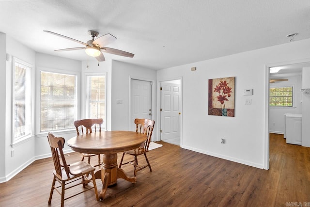 dining area featuring washer / dryer, ceiling fan, dark wood-type flooring, and a textured ceiling