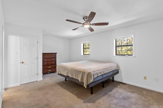 bedroom featuring light carpet, pool table, and ceiling fan