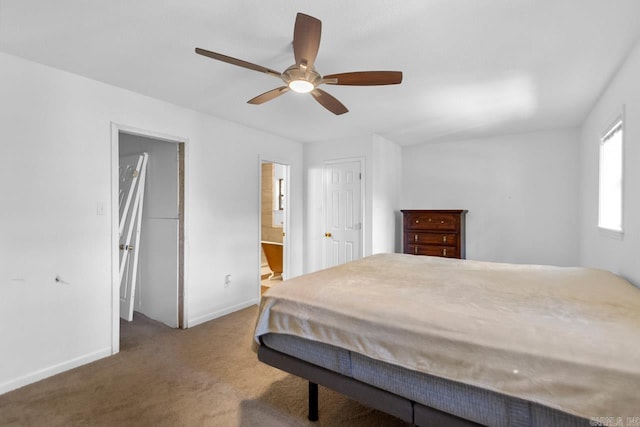 carpeted bedroom with ceiling fan and ensuite bath