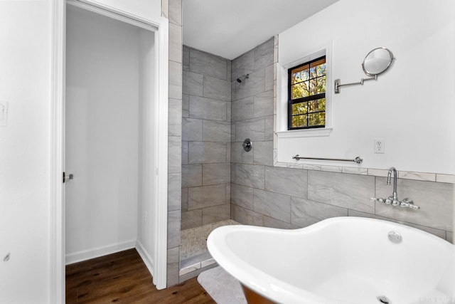 bathroom with tile walls, independent shower and bath, and hardwood / wood-style floors