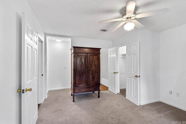 bedroom with ceiling fan and light carpet