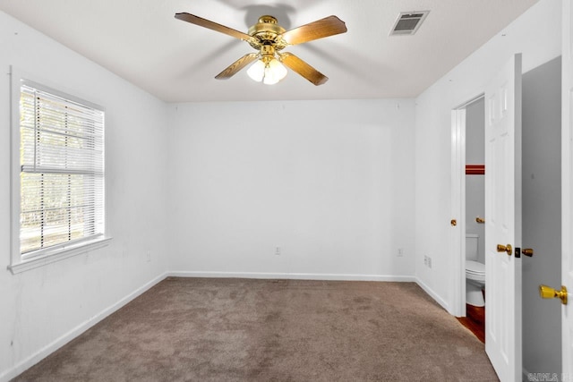 carpeted spare room featuring ceiling fan