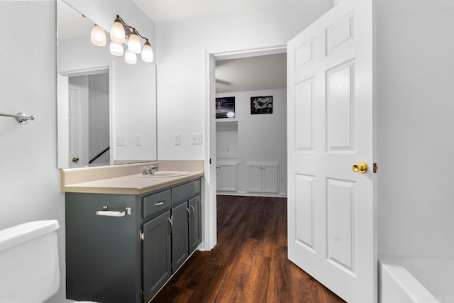 full bathroom with vanity, shower with separate bathtub, toilet, and hardwood / wood-style flooring