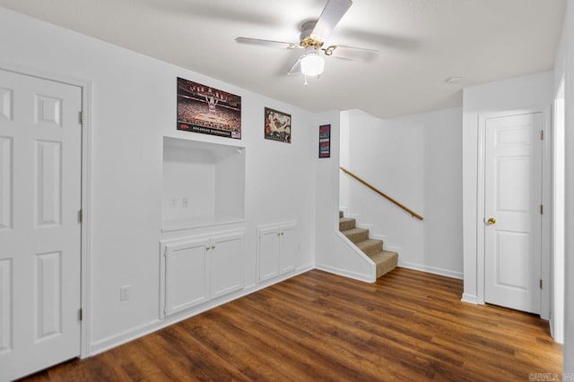 interior space with ceiling fan and dark hardwood / wood-style floors