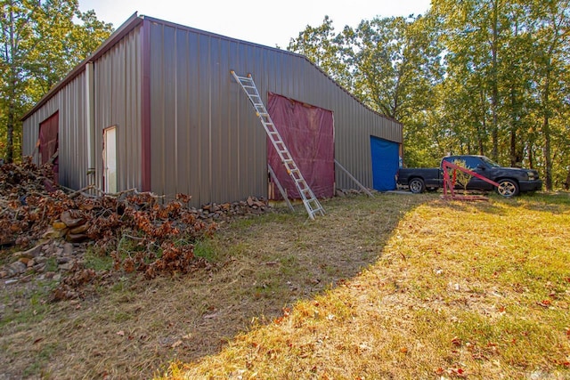 view of outbuilding featuring a yard