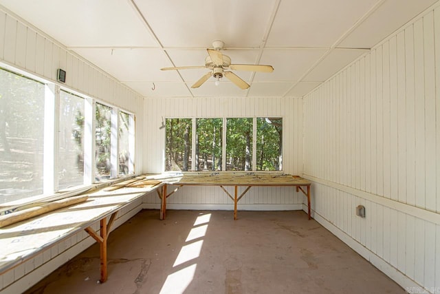 unfurnished sunroom with ceiling fan