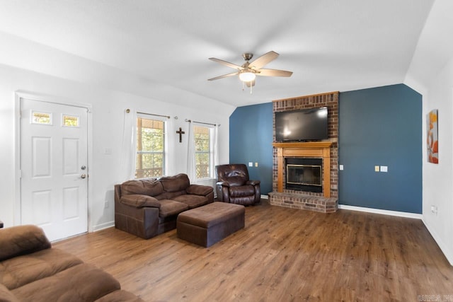 living room with a brick fireplace, vaulted ceiling, ceiling fan, and hardwood / wood-style floors