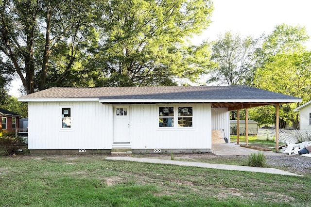 exterior space featuring a carport and a yard